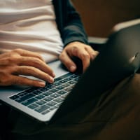 man typing on keyboard
